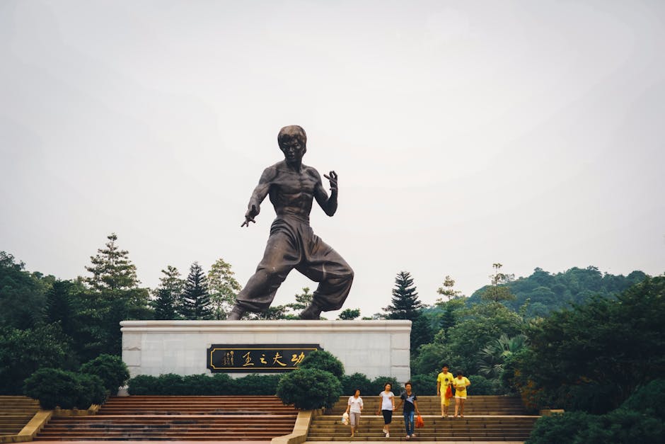 People Near the Statue of Bruce Lee