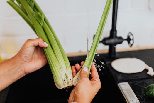 Woman Washing Celery in Kitchen 