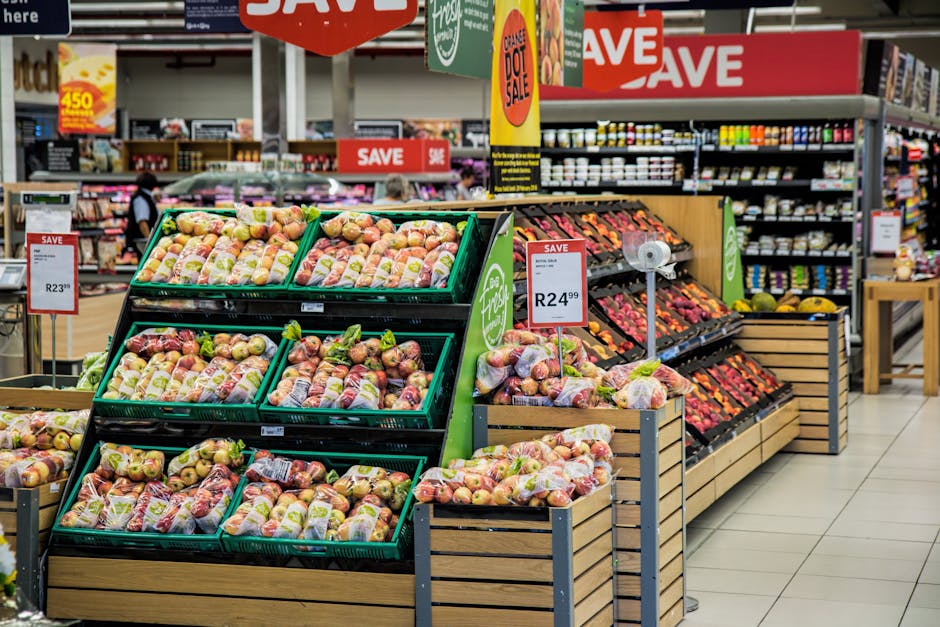 Colorful produce aisle in a supermarket showcasing fresh apples with discount signage.