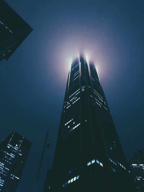 Illuminated Shenzhen skyscraper at night, showcasing architectural elegance and modernity.